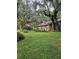 Ranch home with lush green lawn and mature oak trees at 15222 Lost Lake Ln, Lithia, FL 33547