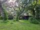 House exterior with covered patio and lush foliage at 15222 Lost Lake Ln, Lithia, FL 33547