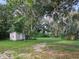 Backyard with shed and large oak trees at 15222 Lost Lake Ln, Lithia, FL 33547