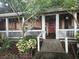 Home features a front porch with white railing and red door at 15222 Lost Lake Ln, Lithia, FL 33547