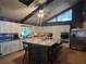 Modern kitchen with white cabinets, granite island, and stainless steel appliances at 15222 Lost Lake Ln, Lithia, FL 33547