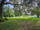 Expansive grassy backyard with mature trees at 15222 Lost Lake Ln, Lithia, FL 33547