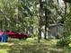 Mobile home nestled among trees, next to a red SUV at 15222 Lost Lake Ln, Lithia, FL 33547