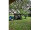 Yard storage area with covered structure and barrels at 15222 Lost Lake Ln, Lithia, FL 33547