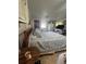 Bedroom with a queen bed, side table, and view of backyard at 15222 Lost Lake Ln, Lithia, FL 33547