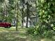 Mobile home with a red SUV parked on the property at 15222 Lost Lake Ln, Lithia, FL 33547