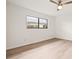 Bedroom with large window and wood-look floors at 4274 Craigdarragh Ave, Spring Hill, FL 34606