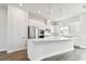 Modern white kitchen with stainless steel appliances and an island at 7412 Newham Ln, Sarasota, FL 34240