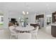 Modern dining area with round table and four chairs, open to kitchen at 2402 N Boulevard, Tampa, FL 33602