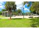 Park with shaded seating areas, playground, and open lawn at 6154 Delaware Ave, New Port Richey, FL 34653