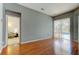 Bright living room with wood floors, access to pool, and view to bedroom at 25954 Risen Star Dr, Wesley Chapel, FL 33544