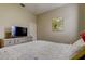 Bright bedroom with TV, dresser, and a comfortable bed at 25954 Risen Star Dr, Wesley Chapel, FL 33544