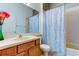 Clean bathroom with shower/tub combo, toilet and wood vanity at 25954 Risen Star Dr, Wesley Chapel, FL 33544