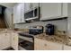 Bright kitchen featuring granite countertops and stainless steel appliances at 25954 Risen Star Dr, Wesley Chapel, FL 33544