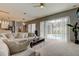Living area showcasing pool access, plush seating, and a coffee table at 25954 Risen Star Dr, Wesley Chapel, FL 33544