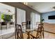 Casual dining area with glass top table and chairs near kitchen and patio at 25954 Risen Star Dr, Wesley Chapel, FL 33544