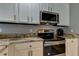 Modern kitchen with stainless steel appliances and granite countertops at 25954 Risen Star Dr, Wesley Chapel, FL 33544