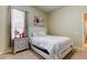 Cozy bedroom featuring a bed, nightstand, and window with blinds at 25954 Risen Star Dr, Wesley Chapel, FL 33544