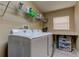 Laundry room with washer, dryer, and ample storage at 25954 Risen Star Dr, Wesley Chapel, FL 33544