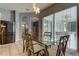 Kitchen dining area with glass table and modern chairs, overlooking backyard at 25954 Risen Star Dr, Wesley Chapel, FL 33544