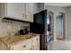 Modern kitchen with stainless steel refrigerator and granite countertops at 25954 Risen Star Dr, Wesley Chapel, FL 33544