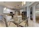 Modern dining area with glass top table and metal chairs near kitchen at 25954 Risen Star Dr, Wesley Chapel, FL 33544