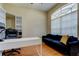 Home office with built-in shelving, desk, and hardwood floors at 25954 Risen Star Dr, Wesley Chapel, FL 33544