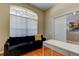 Home office with built-in shelving, desk, and hardwood floors at 25954 Risen Star Dr, Wesley Chapel, FL 33544