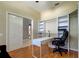 Home office with built-in shelving, desk, and hardwood floors at 25954 Risen Star Dr, Wesley Chapel, FL 33544