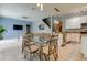 Bright dining area with glass-top table and chairs near kitchen and living room at 25954 Risen Star Dr, Wesley Chapel, FL 33544