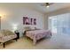 Main bedroom with ceiling fan, access to backyard and a comfortable bed at 25954 Risen Star Dr, Wesley Chapel, FL 33544