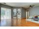Spacious living room with hardwood floors and views into kitchen at 25954 Risen Star Dr, Wesley Chapel, FL 33544