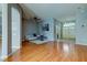 Living room with hardwood floors, off-white couch and entryway view at 25954 Risen Star Dr, Wesley Chapel, FL 33544