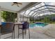 Inviting pool area with covered patio and bar at 25954 Risen Star Dr, Wesley Chapel, FL 33544