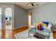 Living room features hardwood floors, a comfy couch, and views to dining area at 25954 Risen Star Dr, Wesley Chapel, FL 33544