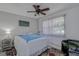 Bright bedroom with a queen-size bed, ceiling fan, and ample closet space at 2438 Enterprise Rd # 6, Clearwater, FL 33763