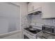 Modern kitchen features a stove, microwave, and stylish backsplash at 2438 Enterprise Rd # 6, Clearwater, FL 33763