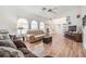 Bright living room features hardwood floors, a comfy sofa, and a large TV at 13199 Drysdale St, Spring Hill, FL 34609