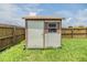 White storage shed in grassy backyard at 13199 Drysdale St, Spring Hill, FL 34609
