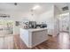 Kitchen features white cabinets, stainless steel appliances and island at 13199 Drysdale St, Spring Hill, FL 34609