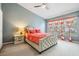 Bedroom with coral bedding, striped curtains, nightstand and ceiling fan at 10227 Estero Bay Ln, Tampa, FL 33625