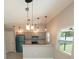 Modern kitchen with teal refrigerator, pendant lighting, and white countertops at 3422 29Th E St, Bradenton, FL 34208