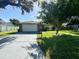 Single-story home with a large front yard, driveway, and attached garage at 3422 29Th E St, Bradenton, FL 34208
