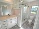 Updated bathroom featuring a walk-in shower, white vanity, and patterned floor tiles at 3422 29Th E St, Bradenton, FL 34208
