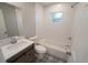 Updated bathroom with white tile, tub and patterned floor at 3422 29Th E St, Bradenton, FL 34208