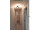 Clean hallway with light gray walls, tile floors, and doors to bedrooms and bath at 3422 29Th E St, Bradenton, FL 34208