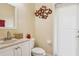 Clean bathroom with white vanity, toilet and access to backyard at 10916 Observatory Way, Tampa, FL 33647