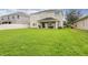 Large backyard with green grass and two-story home at 10916 Observatory Way, Tampa, FL 33647