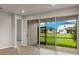 Open living space with sliding doors to a screened patio and backyard views at 6161 Timberdale Ave, Wesley Chapel, FL 33545