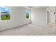 Spacious bedroom with neutral carpeting and large windows at 6161 Timberdale Ave, Wesley Chapel, FL 33545